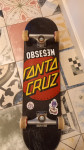 Skateboard z deckom santa cruz.